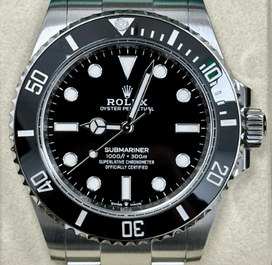 Close-up of a Rolex Submariner Cerachrom ceramic bezel showing the platinum-filled numerals