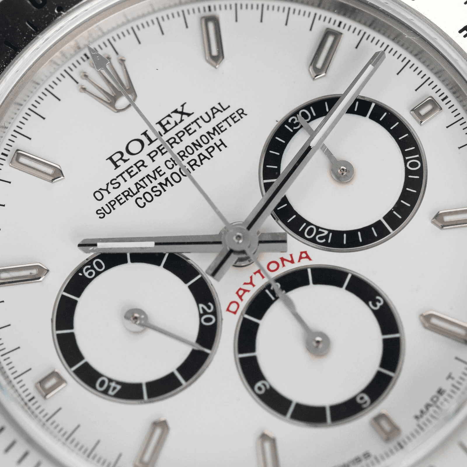 Close-up of Rolex Daytona chronograph pushers and subdials showing the functional racing design