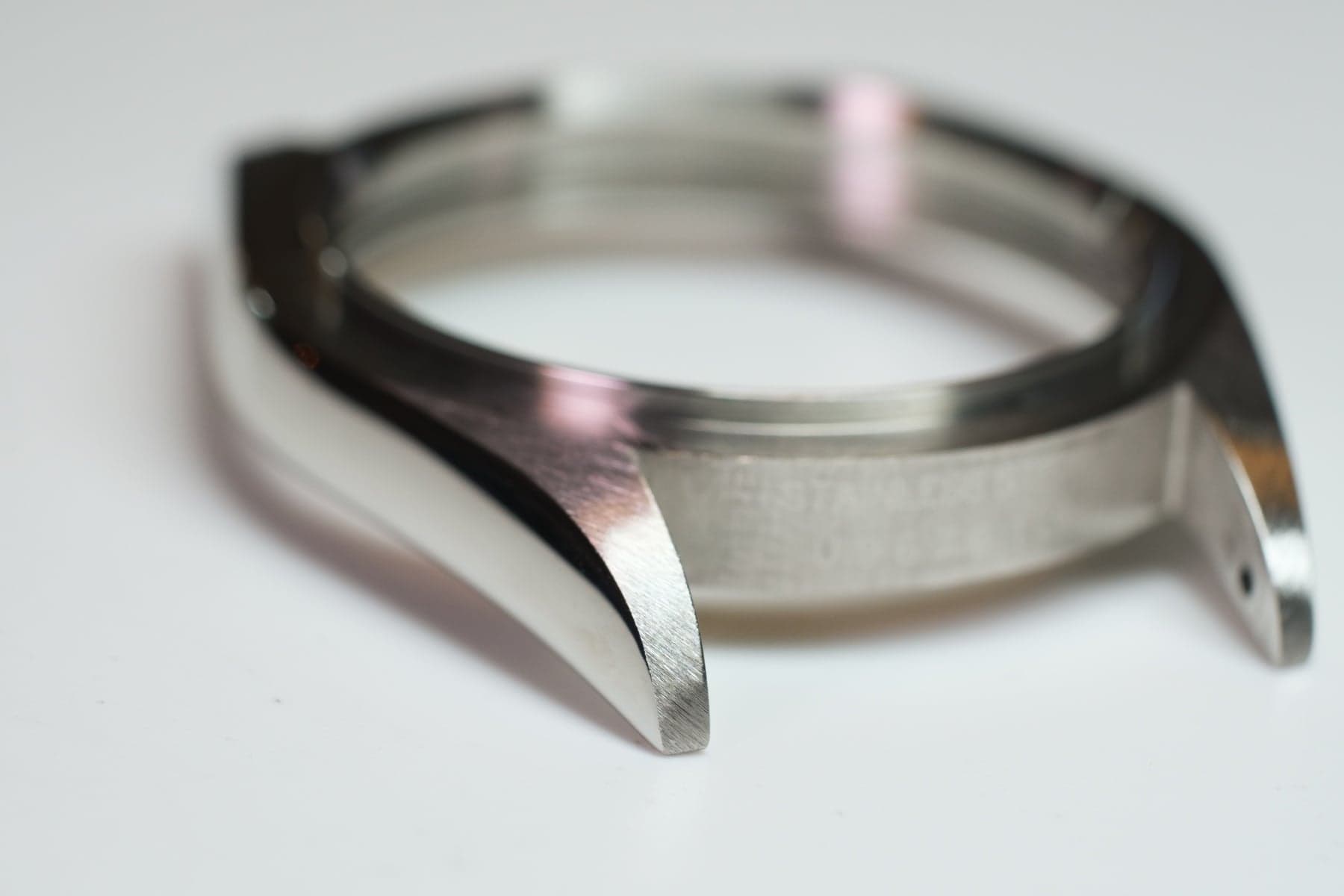 Close-up of genuine Rolex case finishing showing the precise brushed and polished surfaces