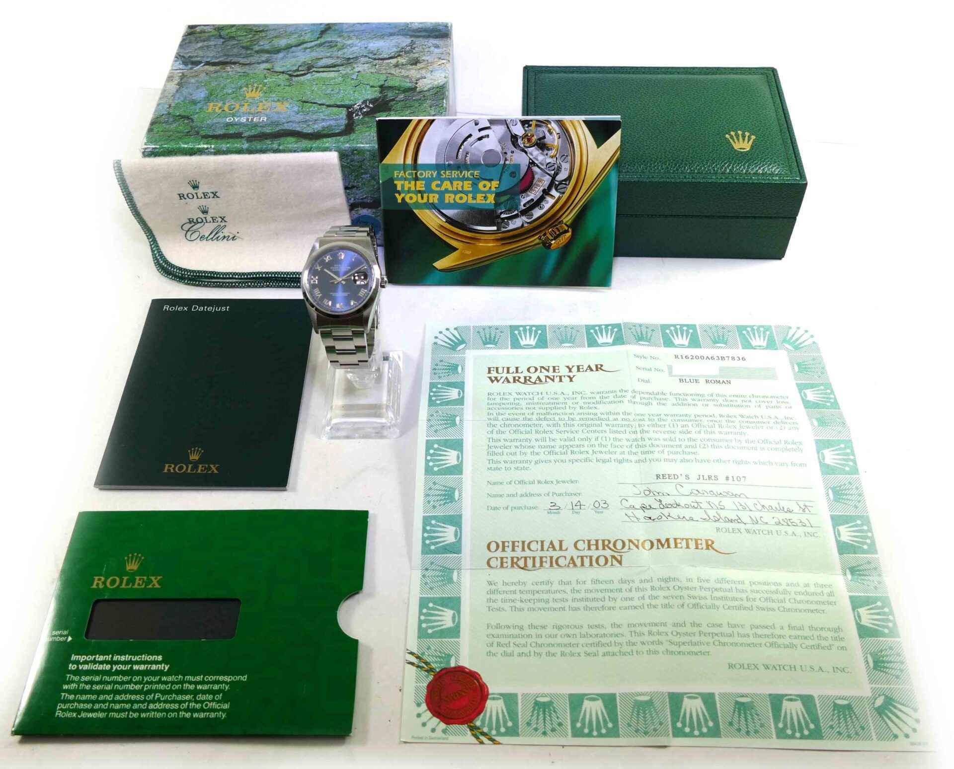 Rolex papers, warranty card, box, and accessories displayed together