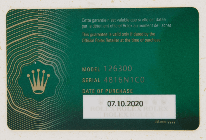 Rolex warranty card showing the serial number and model reference